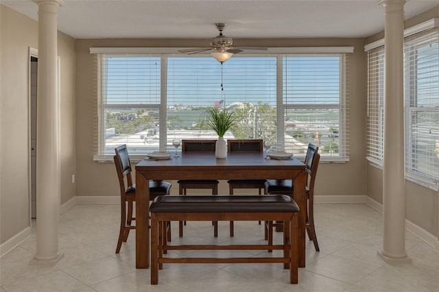 dining room featuring decorative columns, ceiling fan, plenty of natural light, and light tile patterned floors