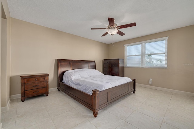 tiled bedroom featuring a textured ceiling and ceiling fan