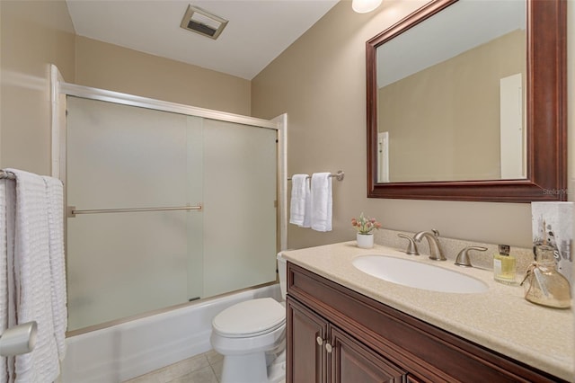 55 Harbor View Ln Unit 301, Belleair Bluffs, FL 33770 - bathroom featuring vanity, toilet, bath / shower combo with glass door, and tile patterned flooring