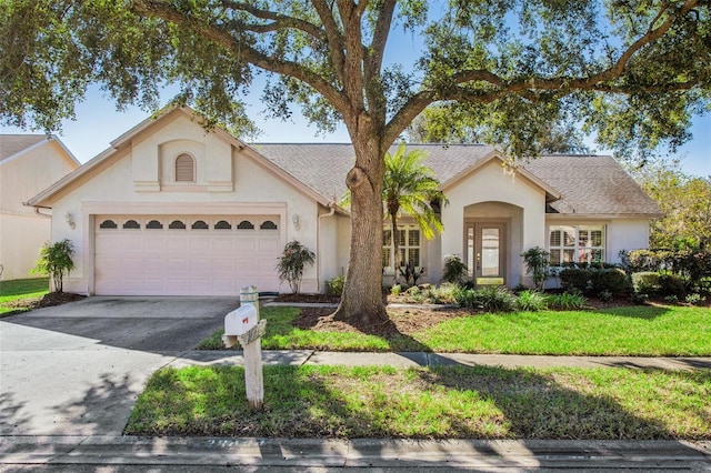 ranch-style house featuring a front yard and a garage