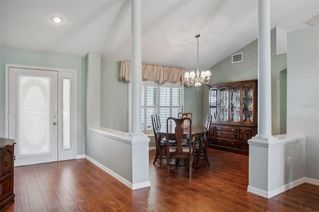 entryway featuring a chandelier, decorative columns, vaulted ceiling, and dark hardwood / wood-style floors