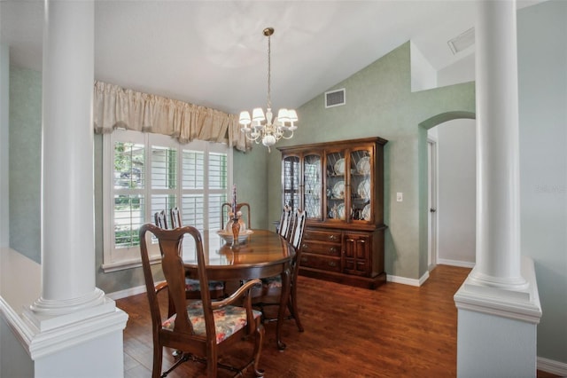 dining space featuring dark hardwood / wood-style floors, high vaulted ceiling, and an inviting chandelier