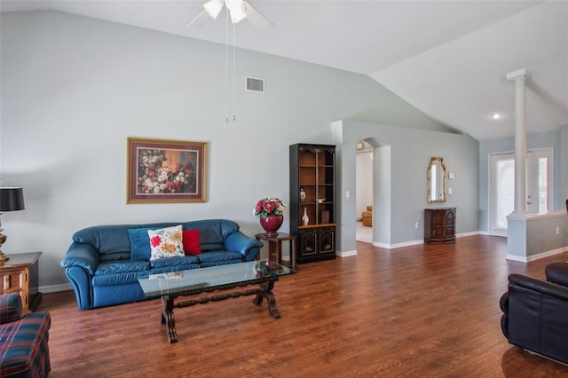 living room with decorative columns, ceiling fan, dark hardwood / wood-style flooring, and vaulted ceiling