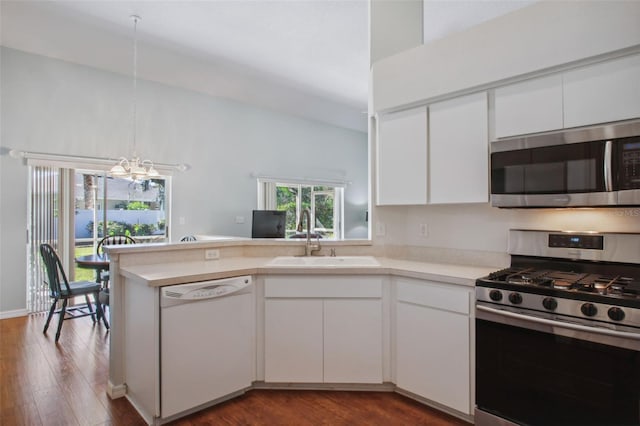 kitchen featuring white cabinetry, sink, stainless steel appliances, an inviting chandelier, and dark hardwood / wood-style flooring