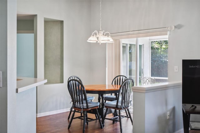 dining room featuring dark wood-type flooring and a notable chandelier