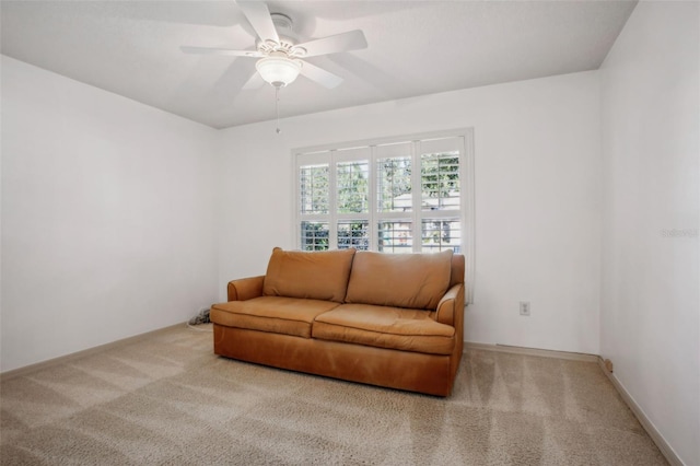 carpeted living room featuring ceiling fan