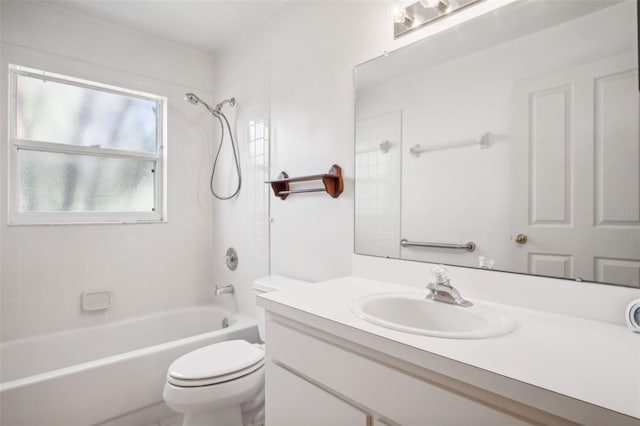 full bathroom featuring vanity, tiled shower / bath combo, and toilet