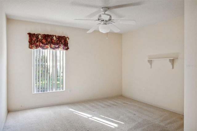 unfurnished room featuring light carpet and ceiling fan