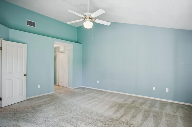 unfurnished bedroom featuring ceiling fan, lofted ceiling, and light carpet