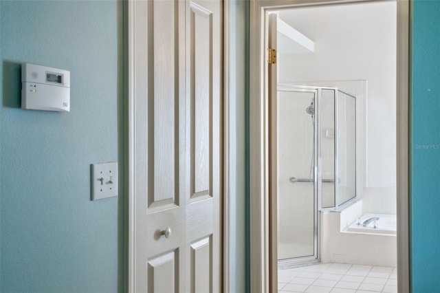 bathroom featuring tile patterned floors and separate shower and tub