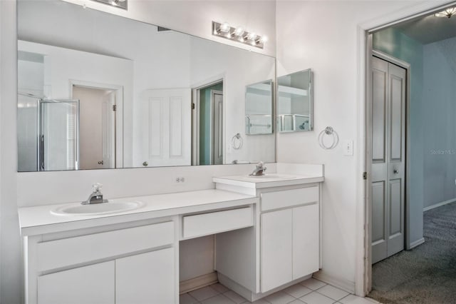 bathroom featuring tile patterned flooring, vanity, and a shower with shower door