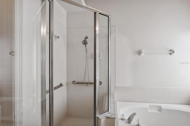 bathroom with separate shower and tub