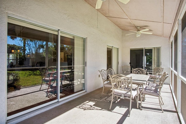 sunroom featuring ceiling fan and lofted ceiling