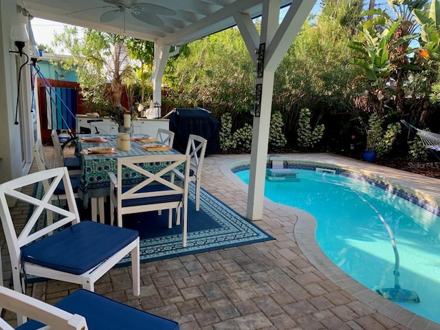 view of swimming pool featuring a patio area and ceiling fan