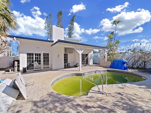 rear view of house featuring a patio area and french doors