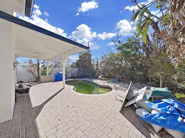 view of patio featuring a fenced in pool