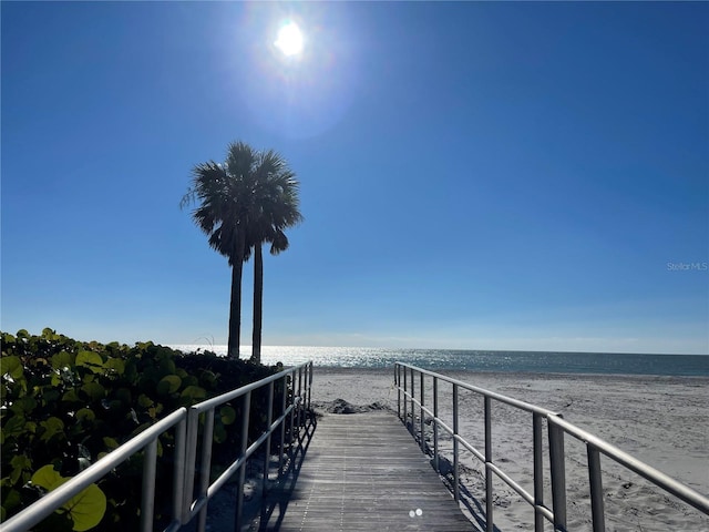 surrounding community with a view of the beach and a water view