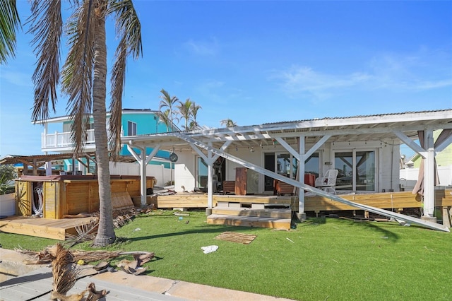 353 144th Ave, Madeira Beach, FL 33708 - rear view of property featuring a deck, a lawn, and a hot tub
