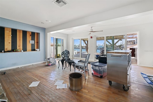 dining space featuring ceiling fan and hardwood / wood-style floors