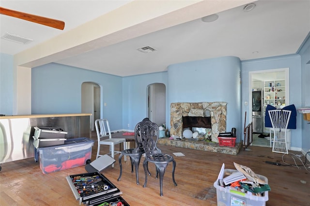 living room featuring a fireplace, hardwood / wood-style flooring, and built in features