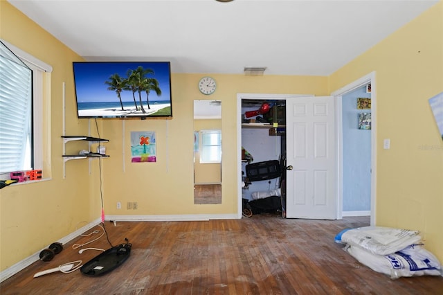 353 144th Ave, Madeira Beach, FL 33708 - unfurnished bedroom featuring wood finished floors, baseboards, and a closet