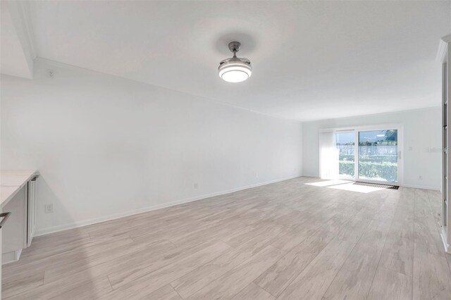 unfurnished room featuring light wood-style flooring and baseboards