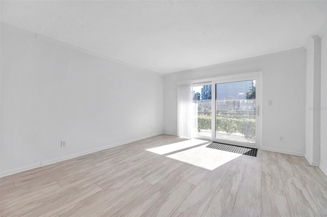 unfurnished room featuring light wood-type flooring and baseboards