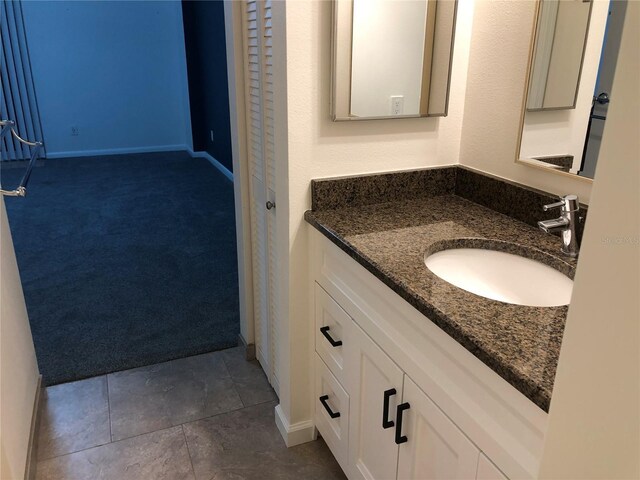 bathroom featuring tile patterned flooring and vanity