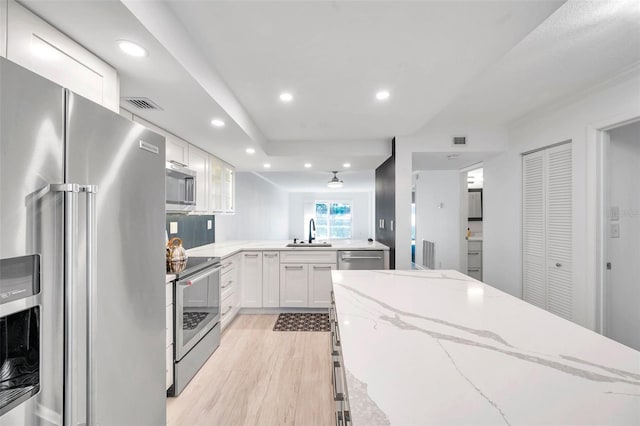 650 Island Way Unit 106, Clearwater Beach, FL 33767 - kitchen with a sink, stainless steel appliances, white cabinetry, visible vents, and recessed lighting
