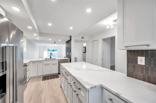 650 Island Way Unit 106, Clearwater Beach, FL 33767 - kitchen featuring recessed lighting, a peninsula, stainless steel appliances, and a sink