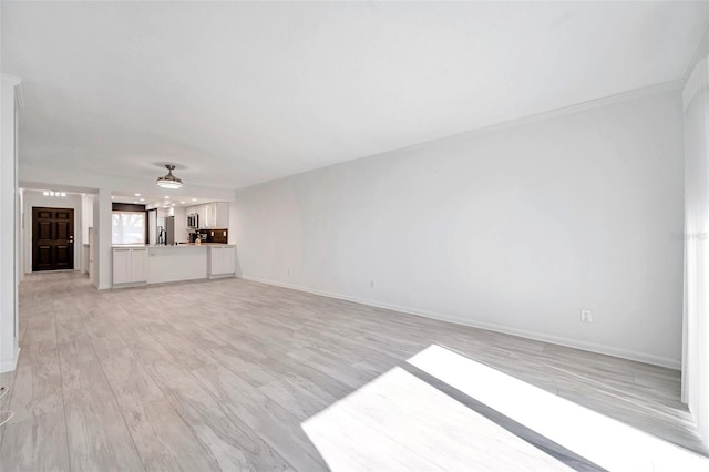 650 Island Way Unit 106, Clearwater Beach, FL 33767 - unfurnished living room featuring light wood-style flooring, baseboards, and ceiling fan