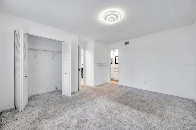 650 Island Way Unit 106, Clearwater Beach, FL 33767 - unfurnished bedroom featuring baseboards, carpet floors, visible vents, and a closet