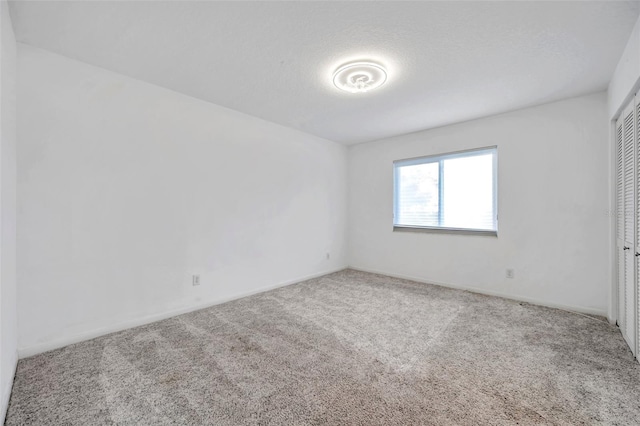650 Island Way Unit 106, Clearwater Beach, FL 33767 - unfurnished bedroom featuring baseboards, a closet, and carpet