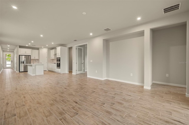 unfurnished living room with light hardwood / wood-style flooring