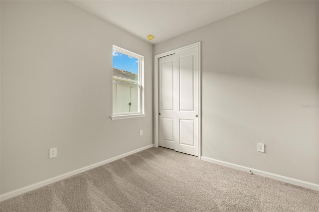 unfurnished bedroom with carpet flooring and a closet