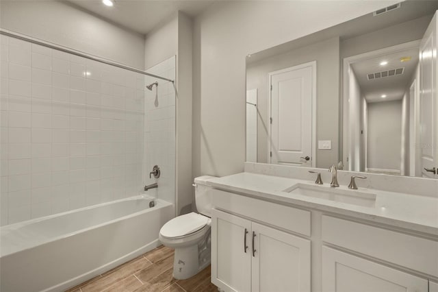 full bathroom featuring vanity, toilet, and tiled shower / bath combo