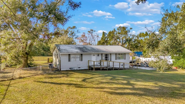 back of house featuring a yard and a wooden deck