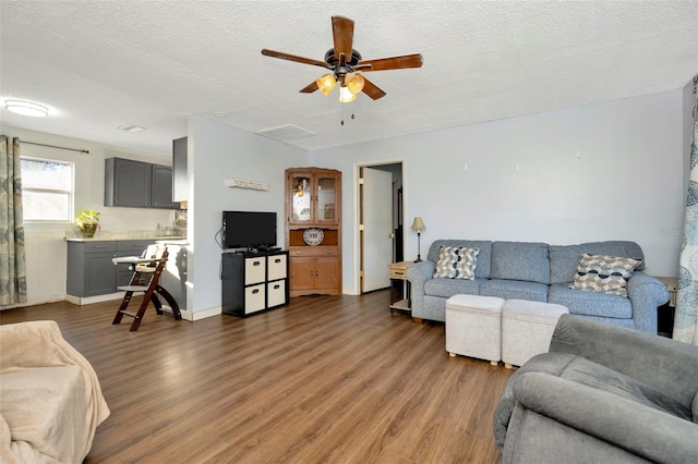 living room featuring dark hardwood / wood-style floors and a textured ceiling