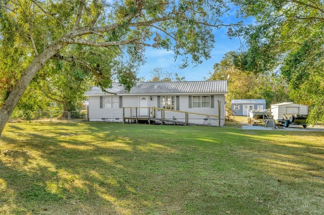 back of house featuring a yard and a wooden deck