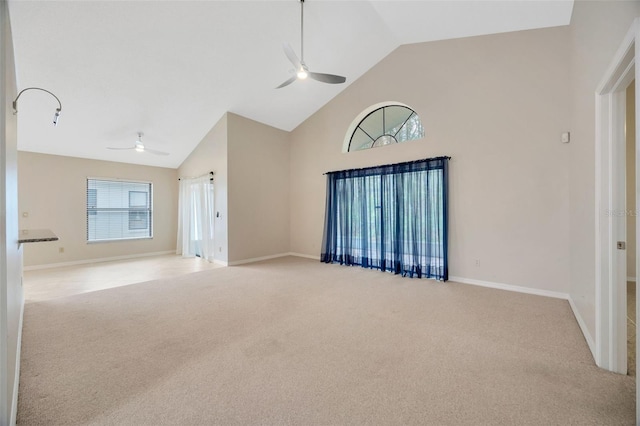 spare room featuring light colored carpet, high vaulted ceiling, and ceiling fan