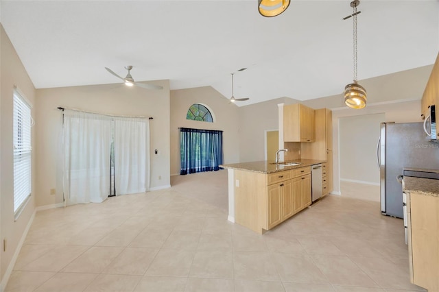 kitchen with a healthy amount of sunlight, sink, stainless steel appliances, and light brown cabinetry