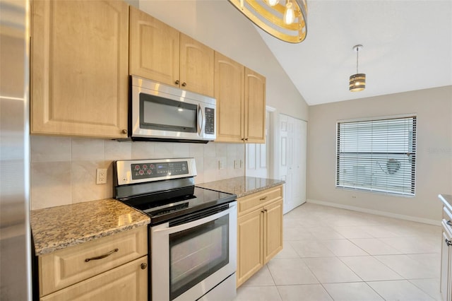 kitchen featuring light brown cabinets, hanging light fixtures, vaulted ceiling, light stone counters, and stainless steel appliances