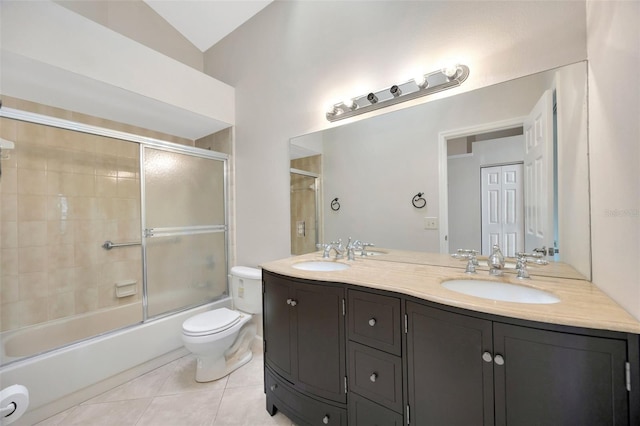 full bathroom with tile patterned floors, lofted ceiling, toilet, shower / bath combination with glass door, and vanity