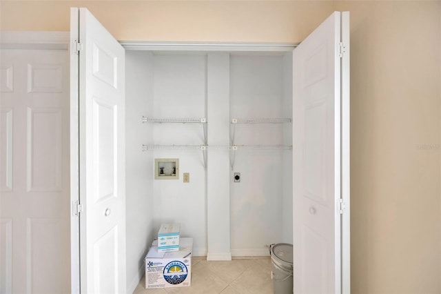 clothes washing area featuring electric dryer hookup, light tile patterned floors, and washer hookup