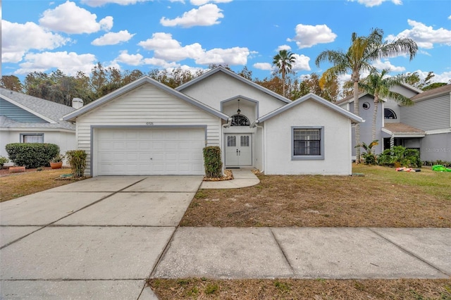 ranch-style house with a garage and a front lawn