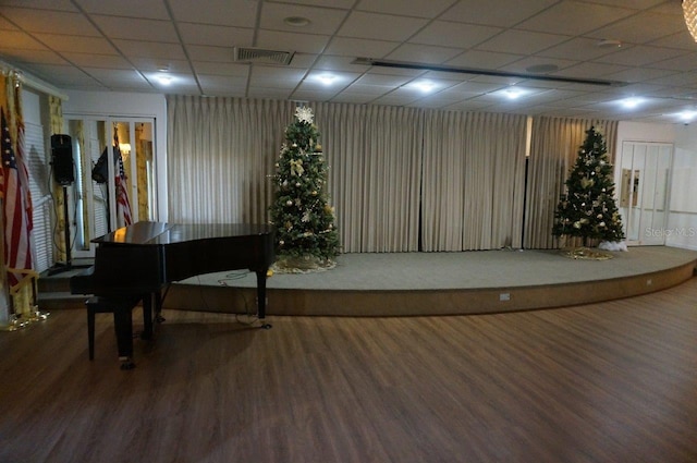 miscellaneous room featuring hardwood / wood-style flooring and a drop ceiling