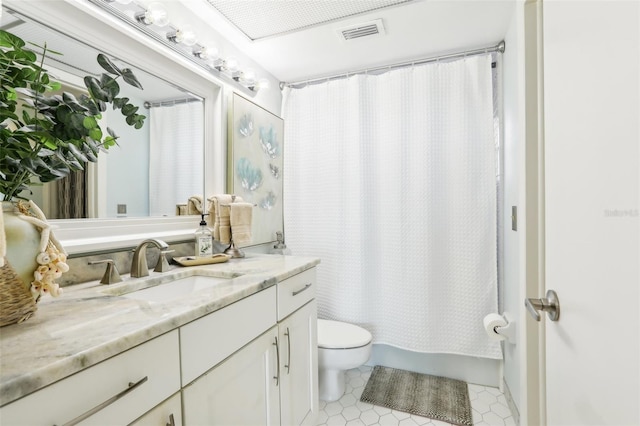 full bathroom featuring tile patterned flooring, toilet, vanity, visible vents, and shower / tub combo with curtain