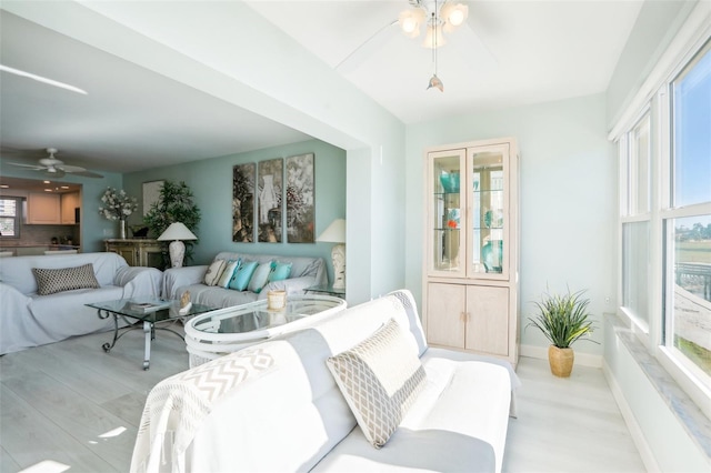 sunroom featuring ceiling fan and a wealth of natural light