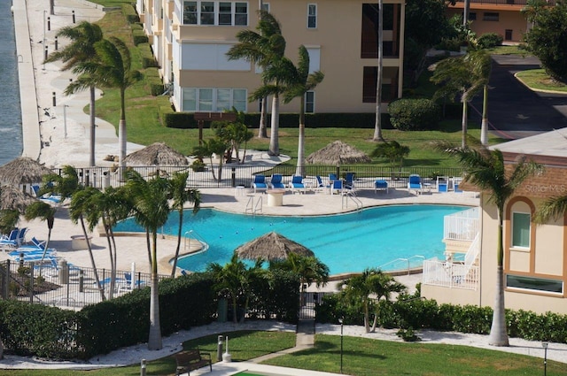 view of swimming pool featuring a patio area and fence