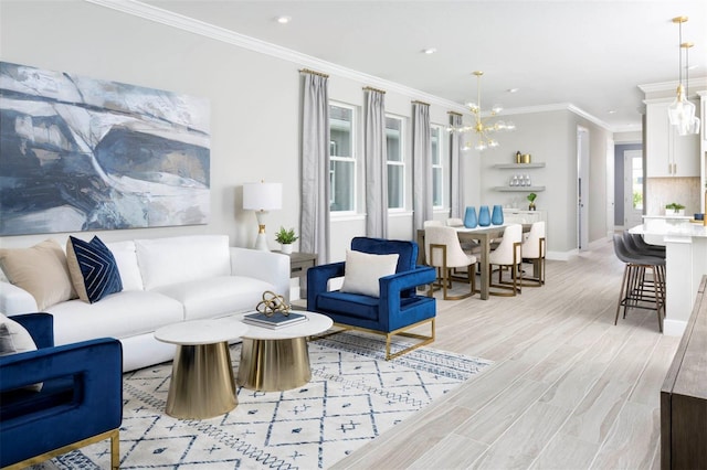 living room with a chandelier, light hardwood / wood-style flooring, and crown molding